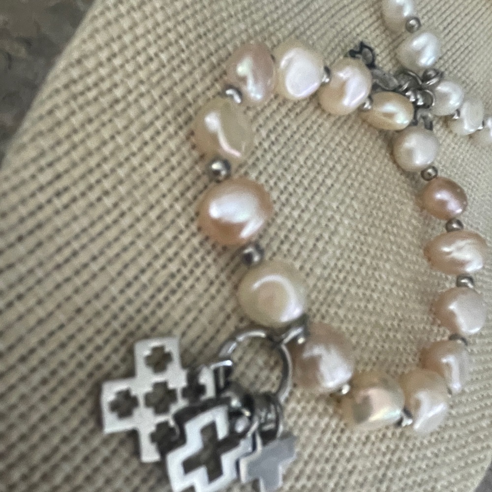 2 Beautiful pearl bracelets one with butterfly & Cross Charms.